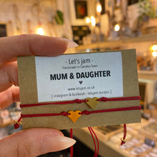 Load image into Gallery viewer, Close-up of the tiny gold heart charm on a burgundy cord bracelet - Let's Jam, Camden Market, London