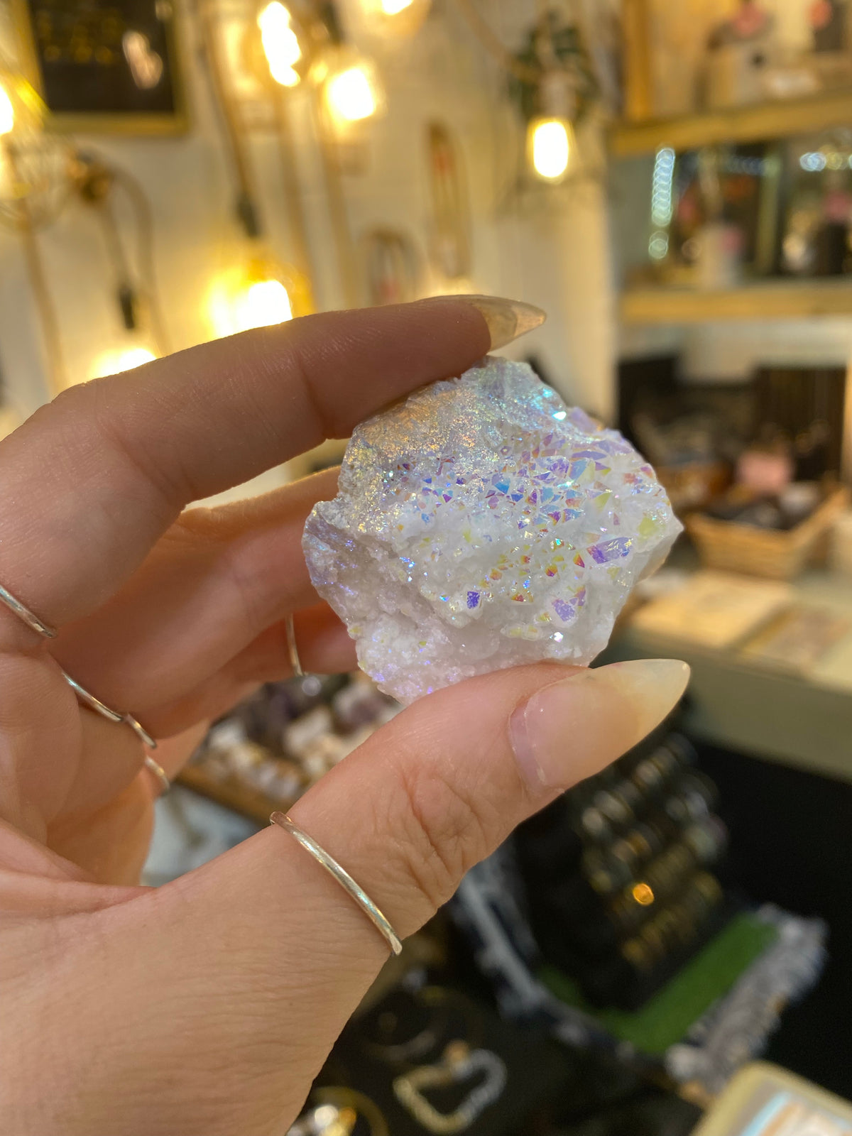 Angel aura quartz cluster held in hand to show its size - Let's Jam crystal shop, Camden Town London