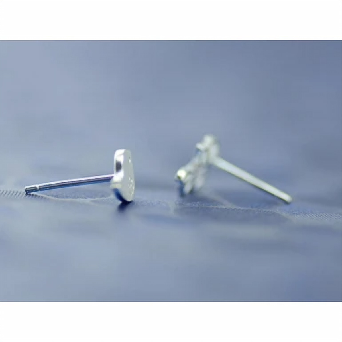 Silver twig stud earring paired with a small bird design - Let's Jam, Camden Market