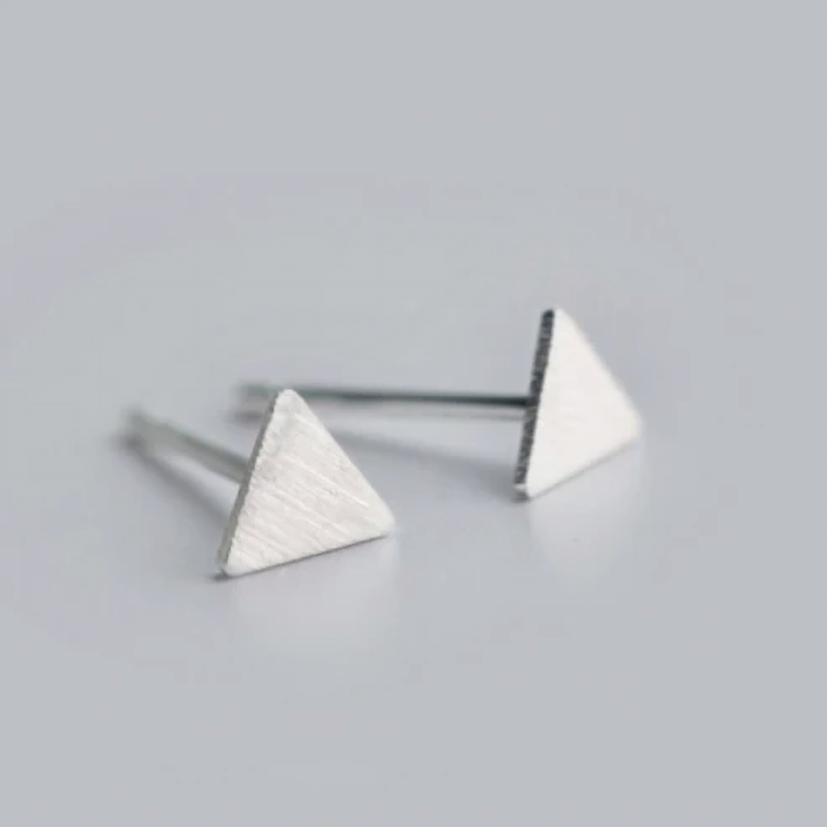 Triangle stud earring worn on the ear - Let's Jam jewellery, Camden Town London