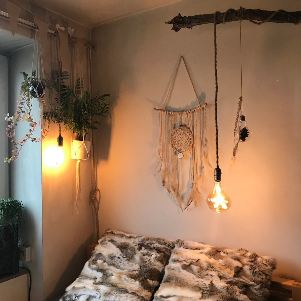 Cosy bedroom corner with a dreamcatcher and two hanging Edison bulb lamps casting warm light - Let's Jam, Camden Town