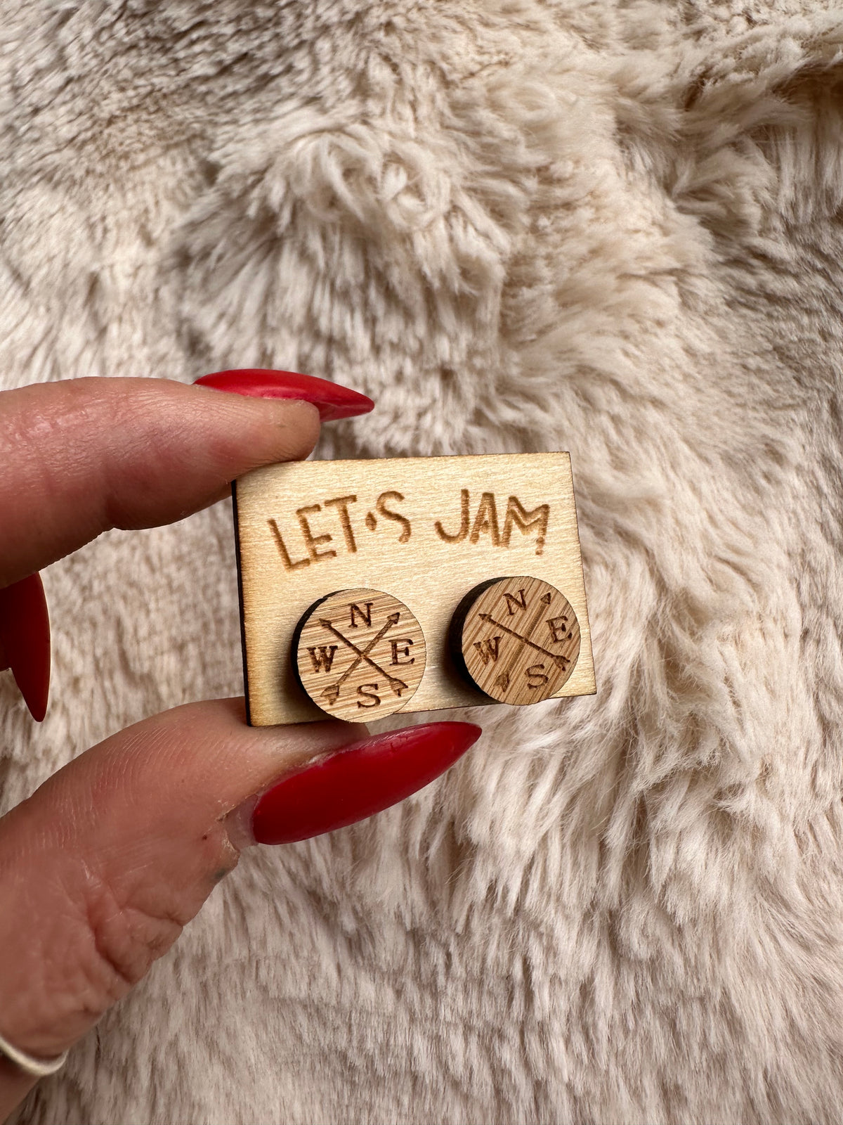 Round wooden stud earrings engraved with a compass rose design - Let's Jam jewellery, Camden Market, London