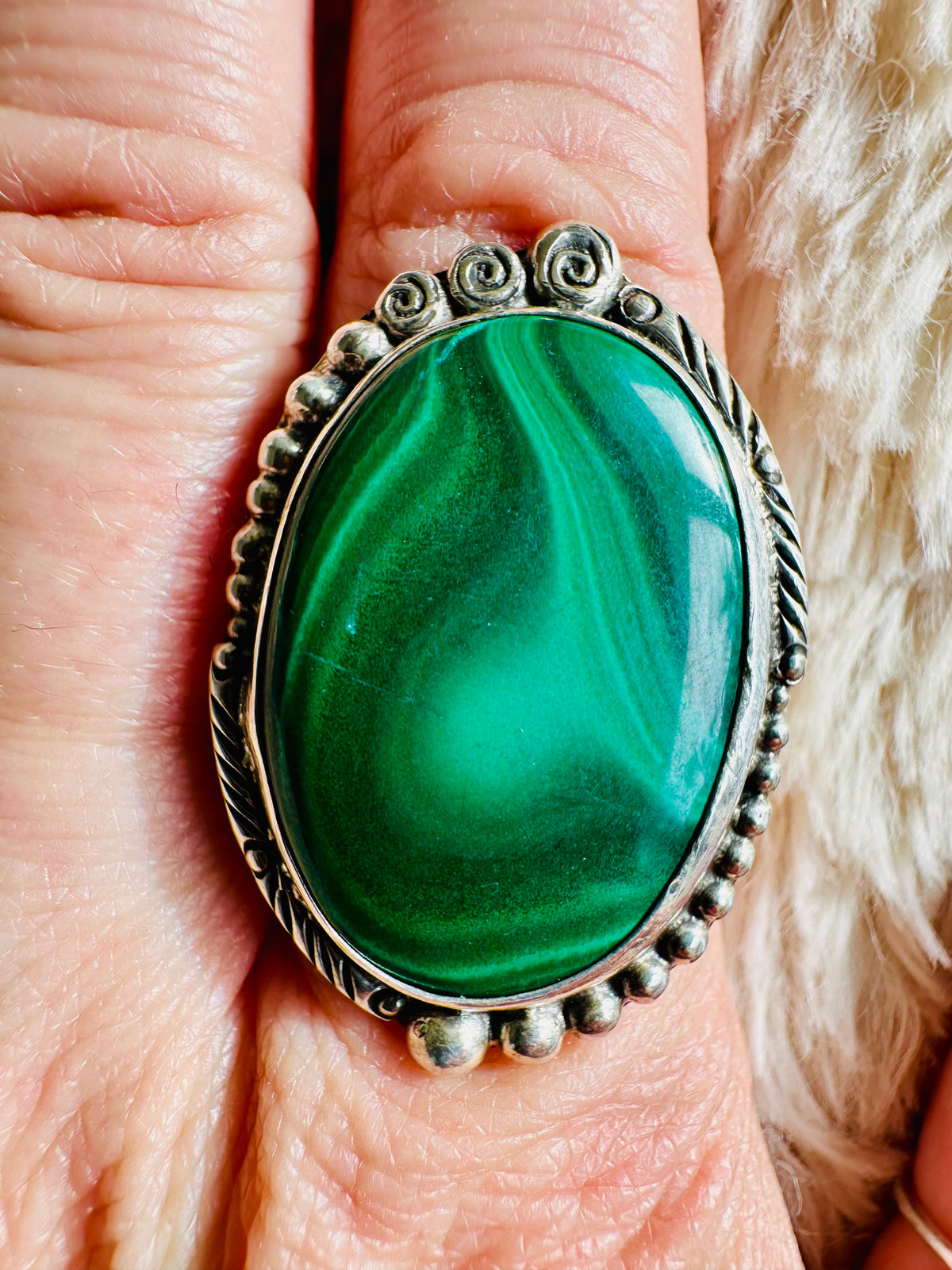 Large oval malachite cabochon with swirling green banding, set in an ornate beaded and scrollwork sterling silver ring - Let's Jam jewellery collection