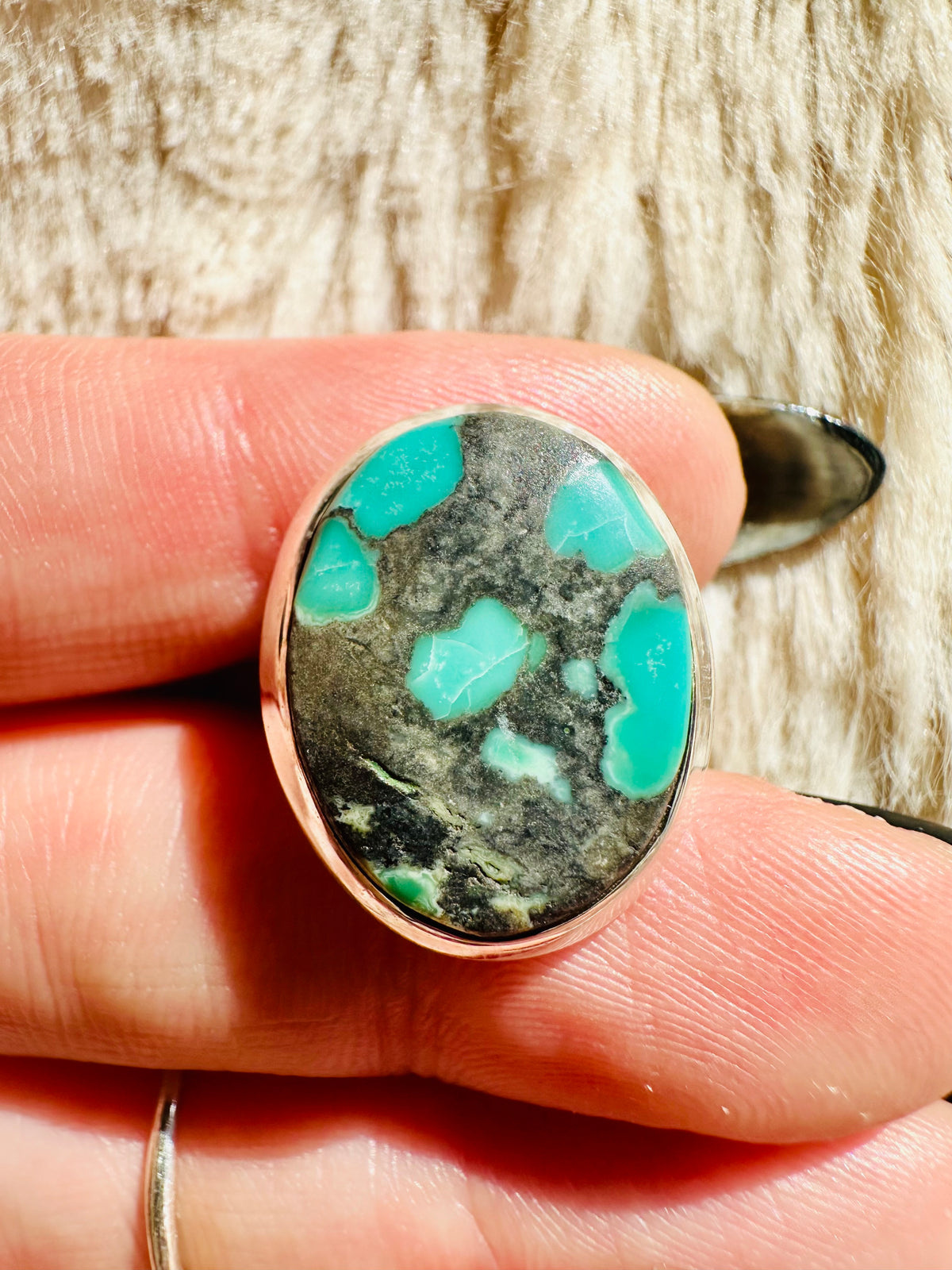 Turquoise cabochon ring with mottled grey-green stone and pooled turquoise patches, set in a smooth warm-toned metal bezel - Let's Jam jewellery collection