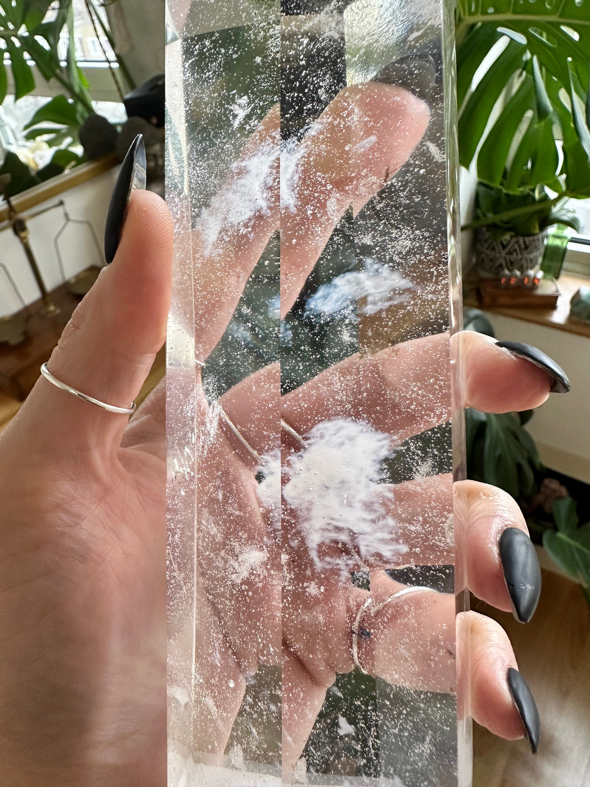 Clear quartz tower with dramatic fracture patterns inside the stone - Let's Jam crystal shop, Camden Market