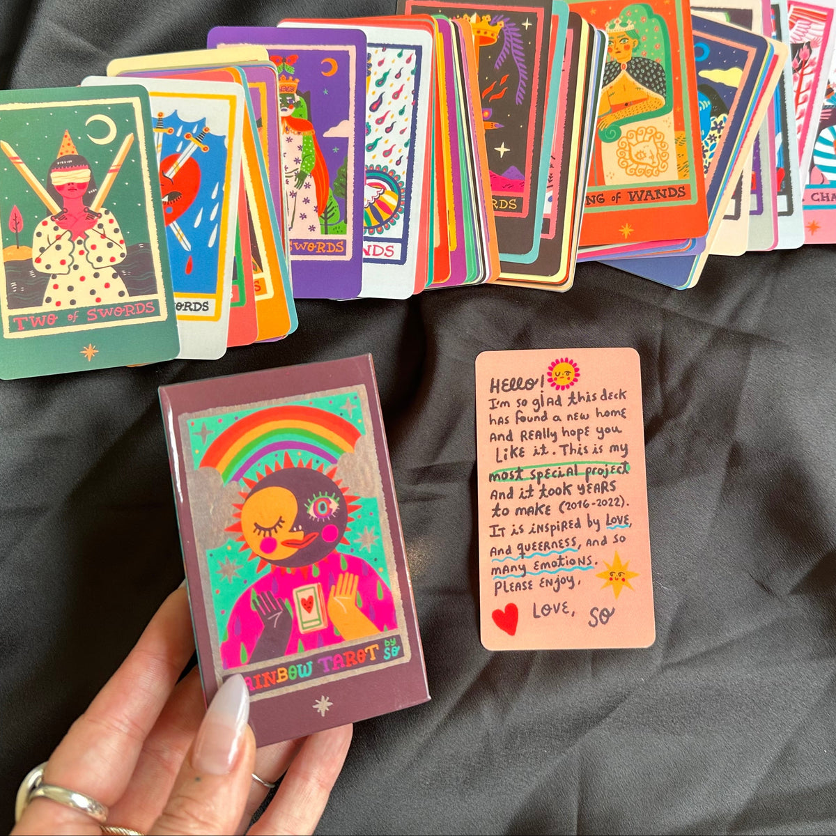 Rainbow Tarot cards fanned out to show their vivid colourful artwork - Let's Jam, Camden Town