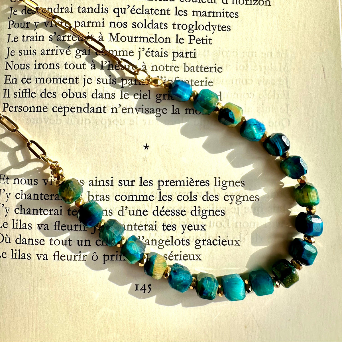 Close-up of the deep blue tiger's eye beads catching the light - Let's Jam jewellery, Camden Market