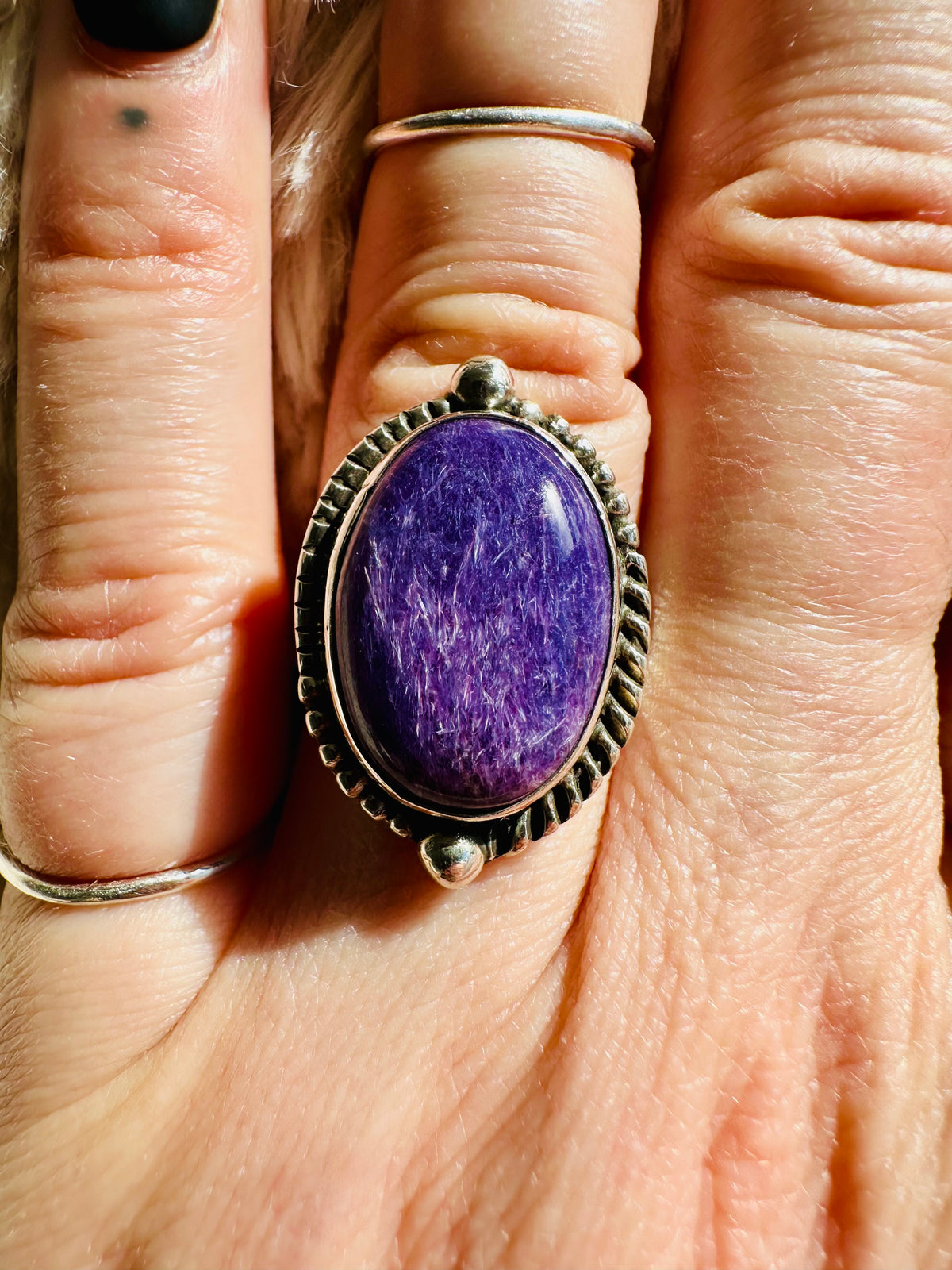 Handmade 925 sterling silver ring with an oval charoite cabochon in vivid purple with fibrous swirling pattern, rope-edge silver bezel with ball accents, one-of-a-kind gemstone ring - Let's Jam jewellery collection
