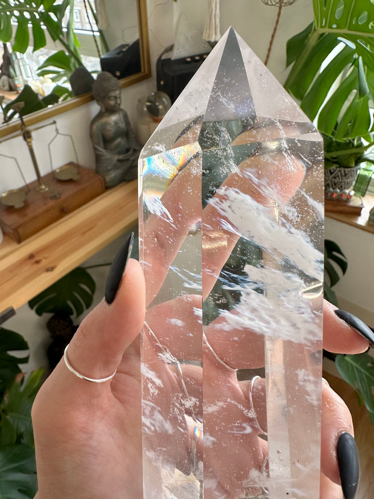 Broad clear quartz tower standing upright beside houseplants - Let's Jam crystals, Camden Market London