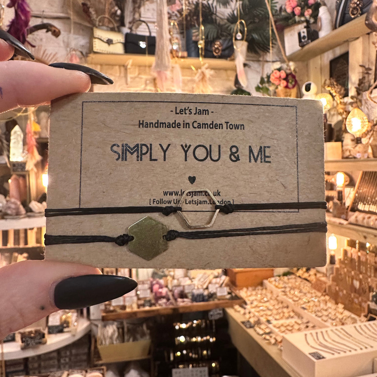 Black cord bracelets with gold hexagon charms on a Let's Jam "Simply You & Me" card - Let's Jam, Camden Market, London