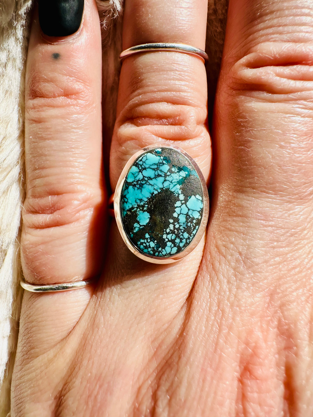 Oval turquoise cabochon ring with dramatic black spider-web matrix veining, set in a smooth sterling silver bezel - Let's Jam jewellery collection