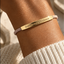 Load image into Gallery viewer, Pink cord bracelet with a gold Gratitude and Resilience bar and a knit sleeve - Let's Jam, Camden Town
