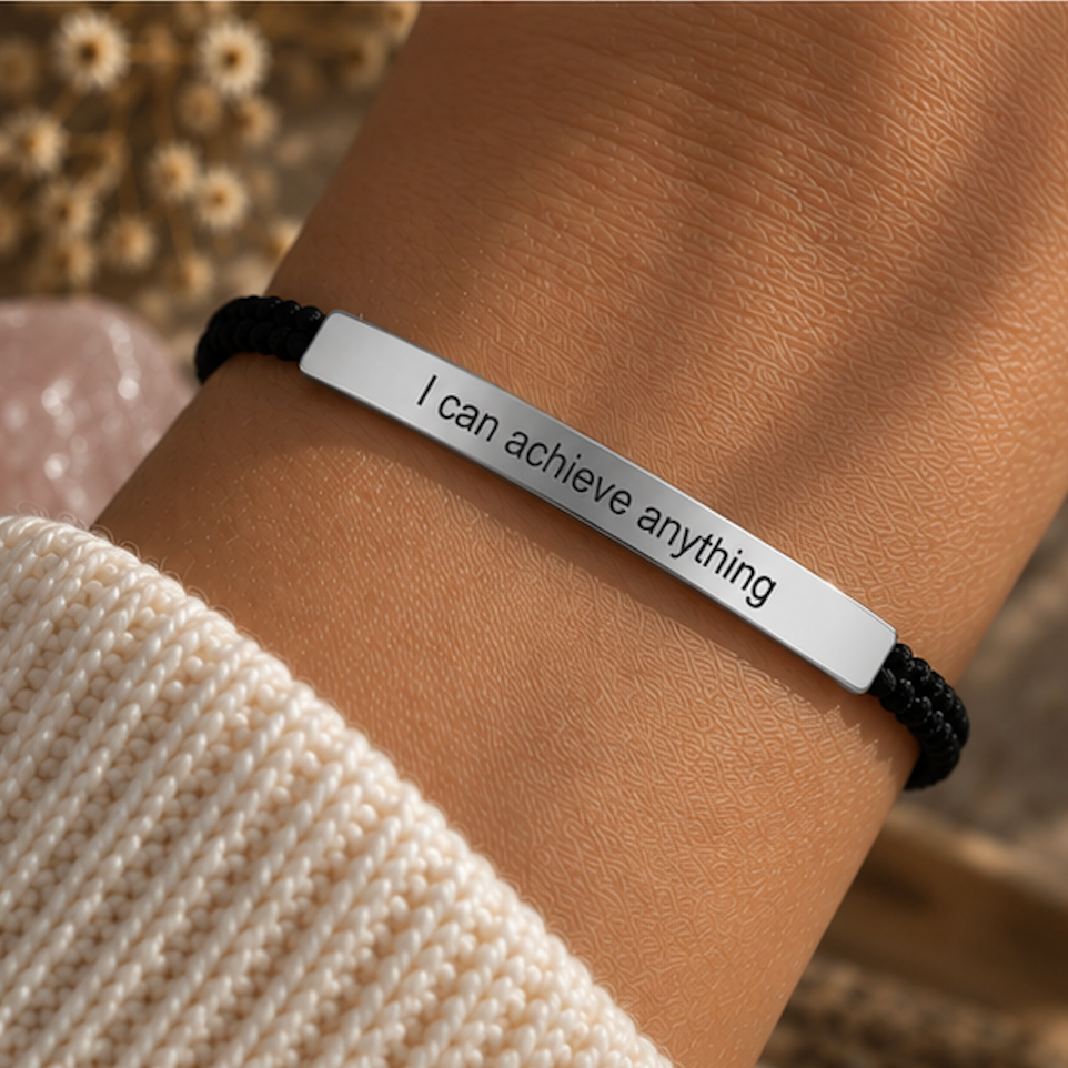Black cord bracelet with a silver engraved bar worn with a knit jumper - Let's Jam jewellery, Camden Market, London