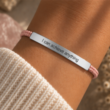 Load image into Gallery viewer, Silver I Can Achieve Anything bar on a pink cord bracelet, worn on the wrist - Let's Jam jewellery, Camden Market
