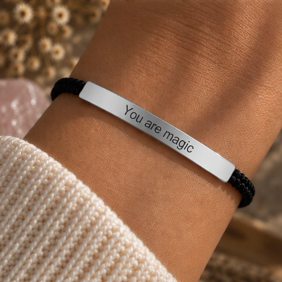 Black cord bracelet with a silver You Are Magic bar worn on the wrist - Let's Jam jewellery, Camden Market, London