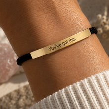 Load image into Gallery viewer, Gold You've Got This bar on a black cord bracelet, worn on the wrist - Let's Jam jewellery, Camden Town
