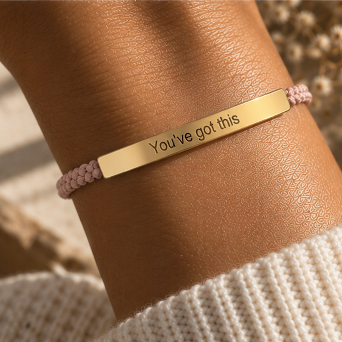 Pink braided bracelet with a gold You've Got This bar in warm sunlight - Let's Jam jewellery, Camden Market London