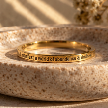 Load image into Gallery viewer, Gold affirmation ring on a beige stone dish - Let's Jam jewellery, Camden Town London
