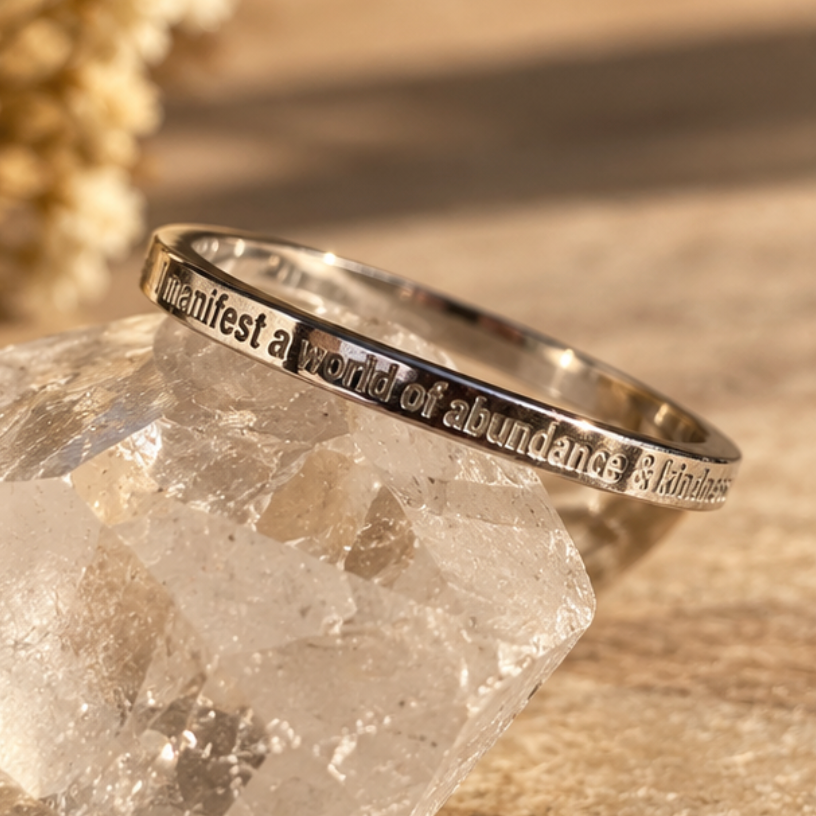 Silver 'I manifest a world of abundance & kindness' ring on a quartz crystal - Let's Jam, Camden Market London