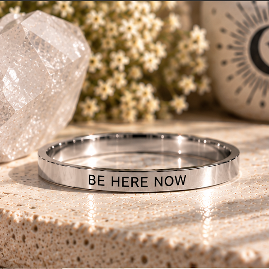 Silver 'Be here now' affirmation ring on a stone surface with a crystal - Let's Jam, Camden Town London