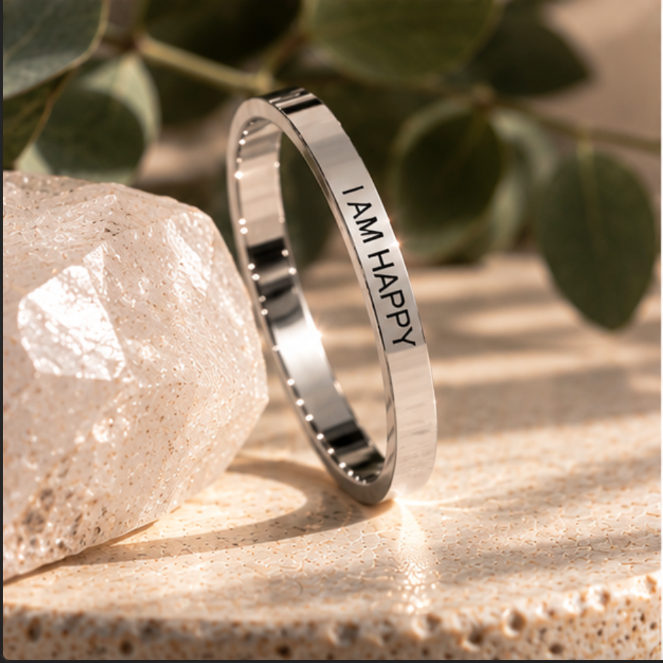 Silver 'I am happy' affirmation ring beside a faceted crystal - Let's Jam jewellery, Camden Market