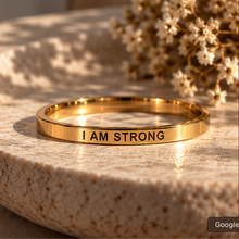 Load image into Gallery viewer, Gold affirmation ring engraved 'I am strong' with dried flowers - Let's Jam, Camden Market London
