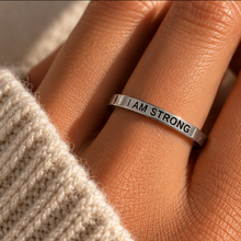 Load image into Gallery viewer, Hand wearing the thin silver 'I am strong' affirmation ring - Let's Jam jewellery, Camden Market

