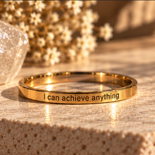 Load image into Gallery viewer, Gold affirmation ring engraved 'I can achieve anything' in golden light - Let's Jam, Camden Market London
