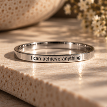 Load image into Gallery viewer, Silver affirmation ring engraved 'I can achieve anything' in dappled sunlight - Let's Jam, Camden Market London
