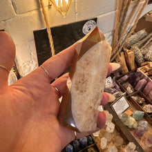 Load image into Gallery viewer, Agate crystal point held up to show its banded pattern - Let's Jam, Camden Market London
