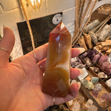 Load image into Gallery viewer, Orange side of the agate tower held in the hand - Let's Jam, Camden Market, London
