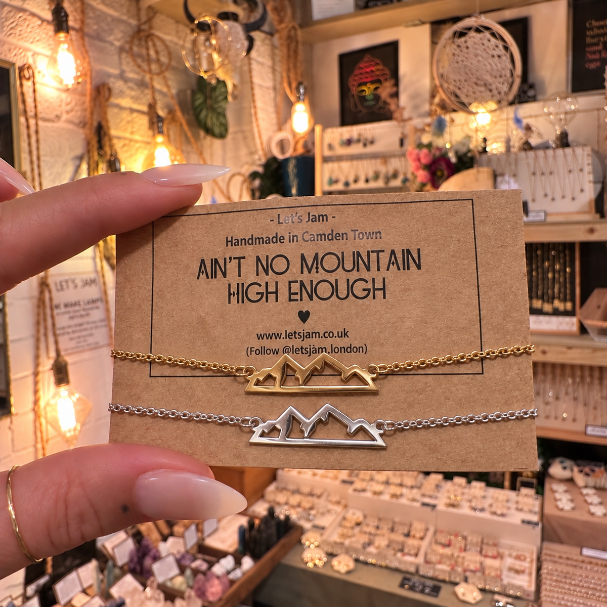 Matching mountain bracelets in gold and silver, worn on two wrists - Let's Jam, Camden Town London