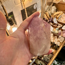 Load image into Gallery viewer, Amethyst point with cut base photographed on display in the shop - Let's Jam, Camden Market
