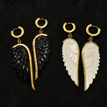 Load image into Gallery viewer, Black and white hand carved angel wing earrings side by side on black velvet - Let's Jam, Camden Market London
