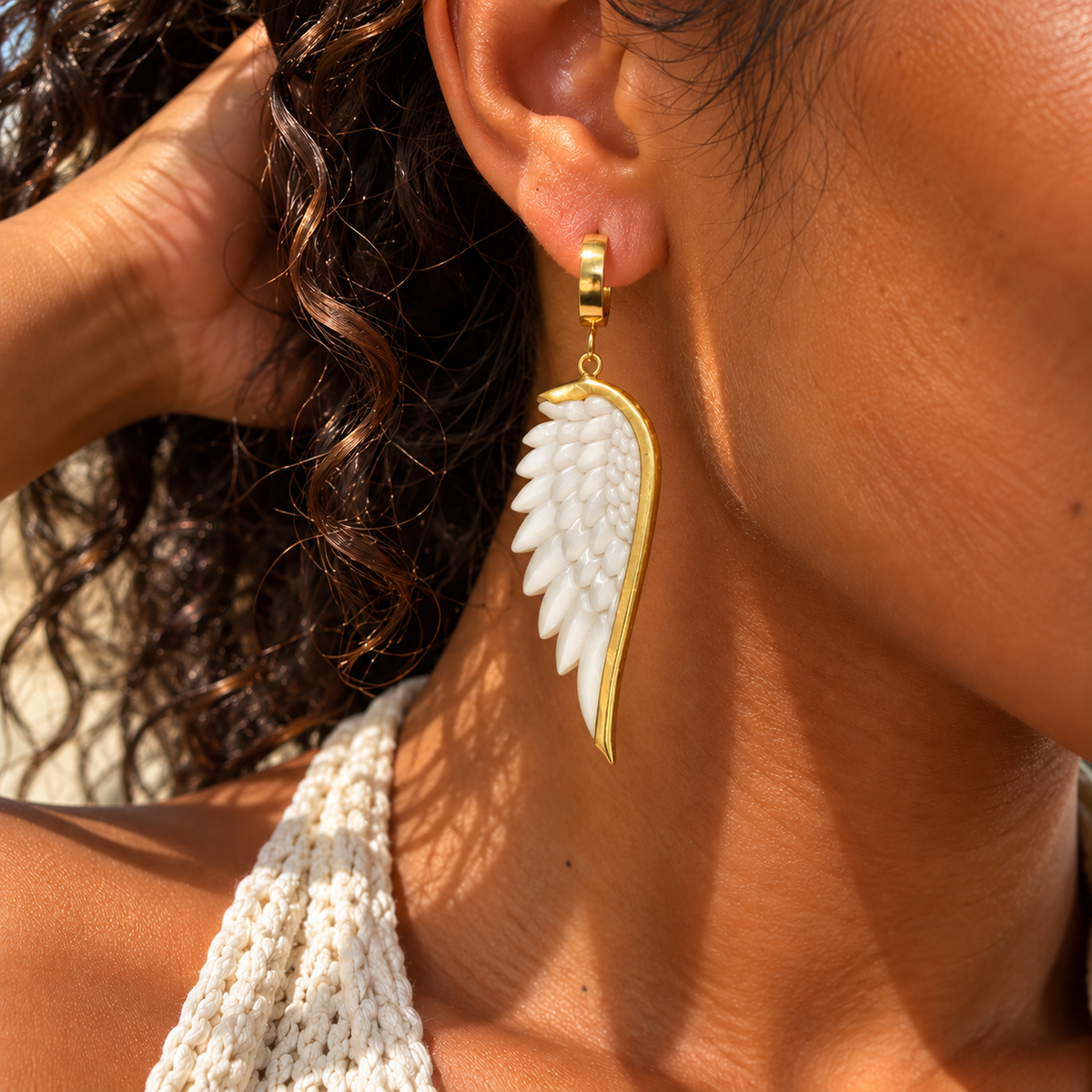 White angel wing drop earring worn with a gold huggie hoop - Let's Jam jewellery, Camden Town
