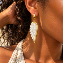 Load image into Gallery viewer, White angel wing drop earring worn with a gold huggie hoop - Let's Jam jewellery, Camden Town
