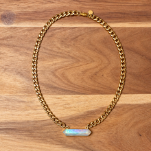 Load image into Gallery viewer, Gold Cuban chain necklace with a rainbow aura quartz point on wood - Let's Jam, Camden Town

