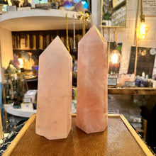 Load image into Gallery viewer, Hand-carved rose quartz point photographed on display in the shop - Let's Jam, Camden Market
