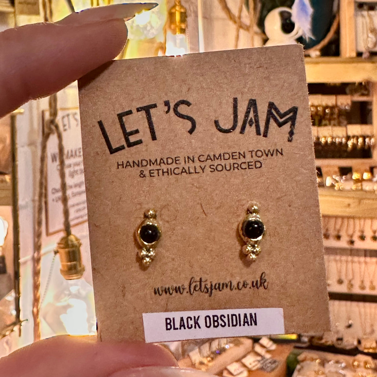 Dainty brass stud earrings with black obsidian stones on their gift card - Let's Jam, Camden Market London