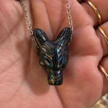 Load image into Gallery viewer, Front of the black wolf head pendant with pricked ears, held in the palm - Let's Jam jewellery, Camden Town London
