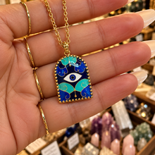 Load image into Gallery viewer, Blue enamel third eye arch pendant held in the hand - Let's Jam, Camden Market London
