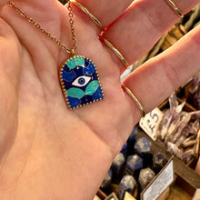 Load image into Gallery viewer, Blue enamel evil eye arch pendant on a gold chain held in the hand - Let's Jam, Camden Town

