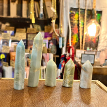 Load image into Gallery viewer, Five pale blue Caribbean blue calcite towers standing together in the shop - Let's Jam, Camden Market London

