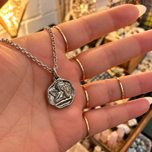 Load image into Gallery viewer, Silver cherub cupid medallion held in the hand - Let's Jam jewellery, Camden Market
