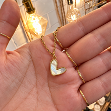 Load image into Gallery viewer, Gold cute mother of pearl heart pendant held in the hand - Let's Jam, Camden Market, London
