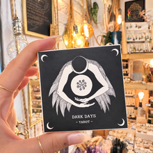 Load image into Gallery viewer, Dark Days Tarot square black box held in the hand in the shop - Let's Jam, Camden Market
