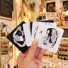 Load image into Gallery viewer, Square black and white Dark Days cards held in the hand - Let's Jam, Camden Market London
