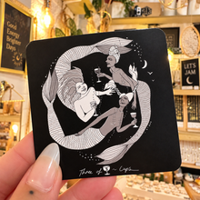 Load image into Gallery viewer, Black square Three of Cups card with mermaids swimming in a circle - Let's Jam, Camden Market, London
