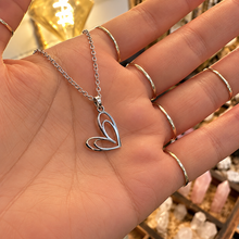 Load image into Gallery viewer, Silver open double heart pendant held in the hand - Let's Jam jewellery, Camden Market
