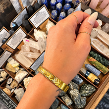 Load image into Gallery viewer, Gold arrow clip bangle worn on the wrist - Let's Jam, Camden Town London
